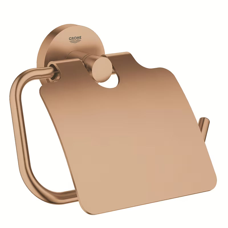 Držalo za toaletni Papir Grohe Essentials s pokrovom v izvedbi Brushed Warm Sunset s skritim pritrjevanjem.