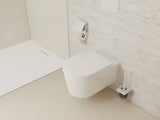 Stenska WC ščetka hansgrohe addstoris v mat beli barvi z držalom iz kovine in s stekleno posodo.
