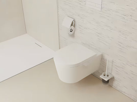 Stenska WC ščetka hansgrohe addstoris v mat beli barvi z držalom iz kovine in s stekleno posodo.