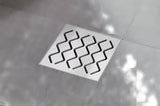Talni sifon Ravak SN501 s plastičnim ohišjem in rešetko iz nerjavečega jekla, premer 10,5 cm.