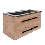 Viseča kopalniška omarica SAT Cube Way s keramičkim umivaonikom u dekoru hrasta Wellington i crnim ručkicama.