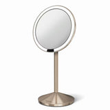 Potovalno kozmetično ogledalo Simplehuman Mini v barvi rose gold z osvetlitvijo Tru-lux Led in 10-kratno povečavo.