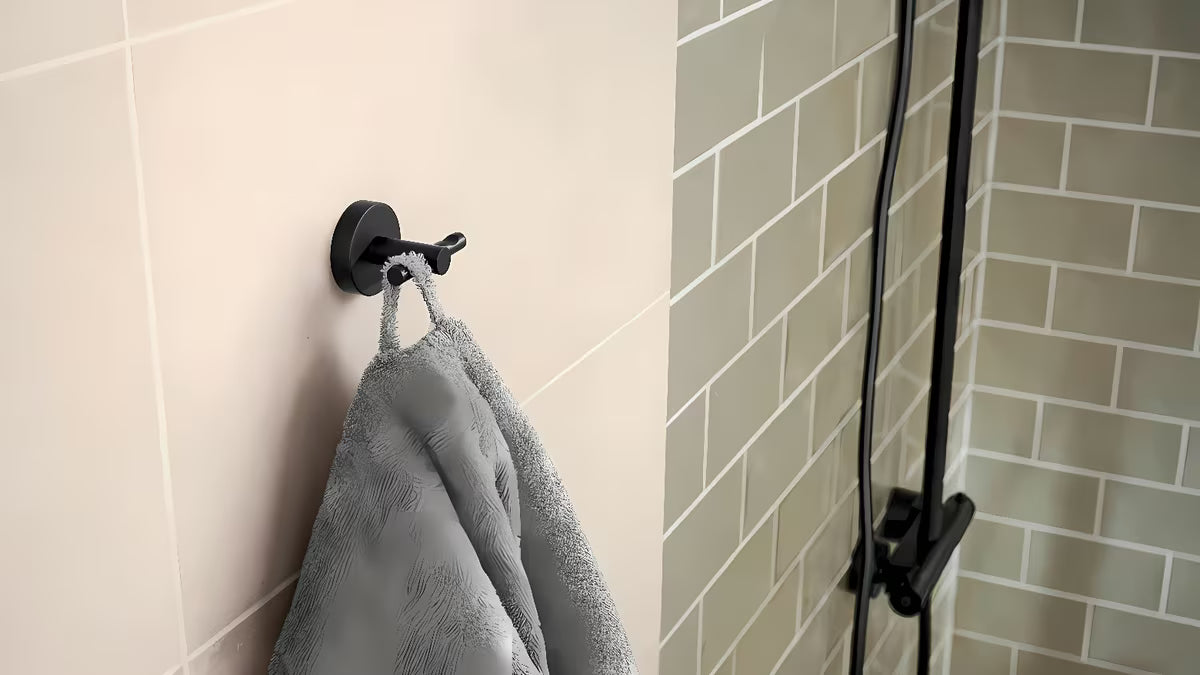 Metalni kavelj za ogrtač Tesa u brušenoj izvedbi hard graphite s ljepljivom montažom bez bušenja