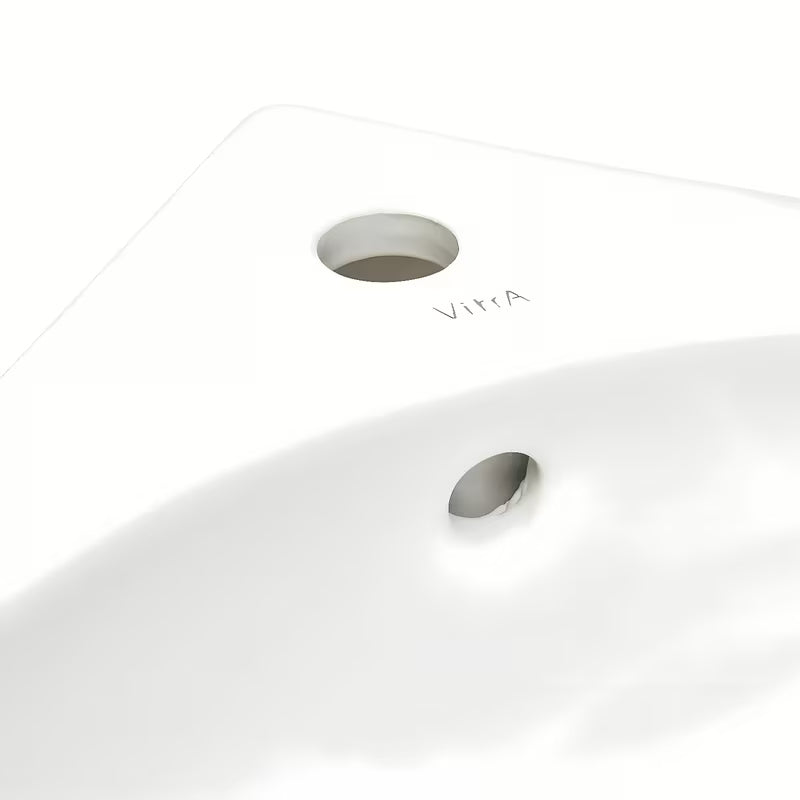 Beli kotno umivalnik vitra Integra 56x40 cm s prelivom in odprtino pro za armaturo na sredini
